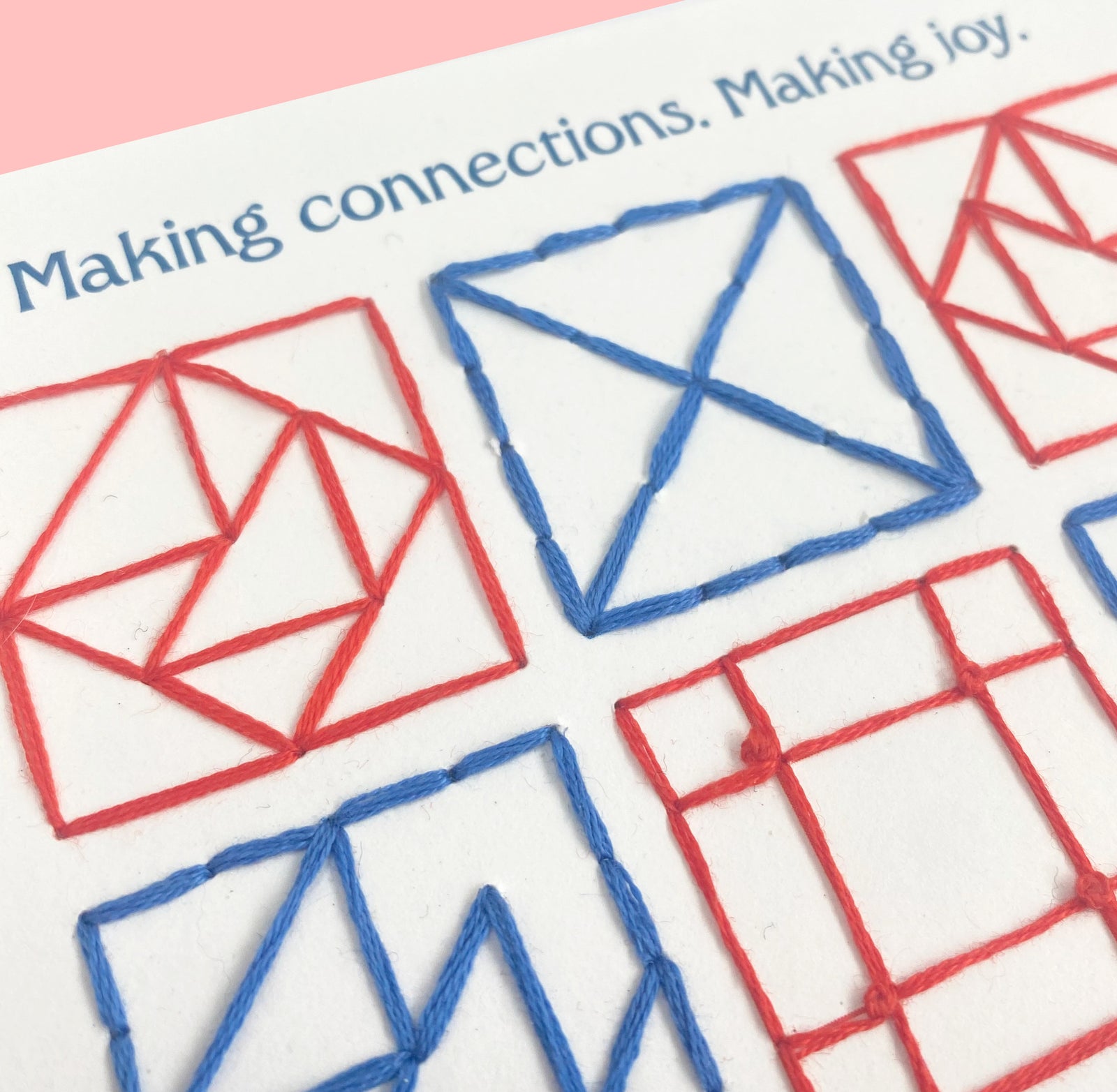 White paper with quilt square embroidery in blue and red. On the top it ways making connectons, making joy.