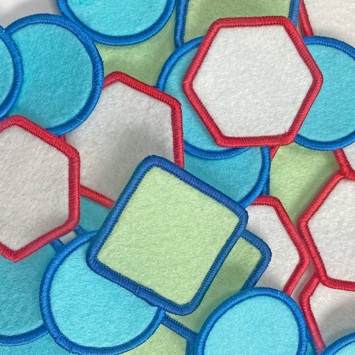 Colorful geometric patches with red, blue, and lime green shapes showing the variety in this pack
