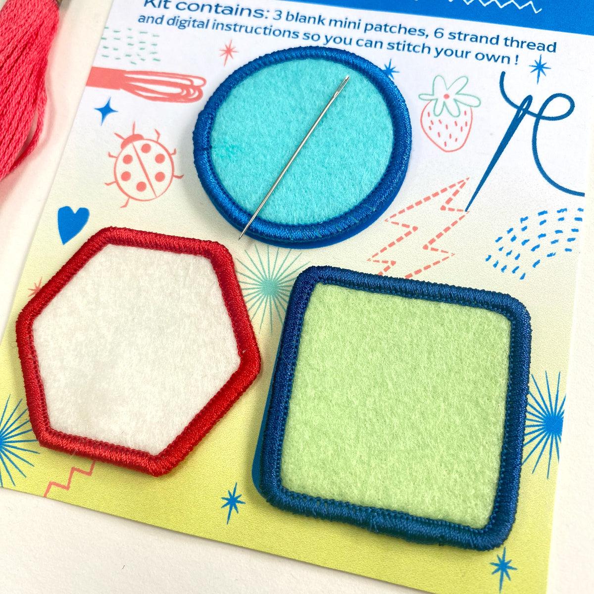 Colorful patchwork kit with patches, thread, and needle on a colorful background