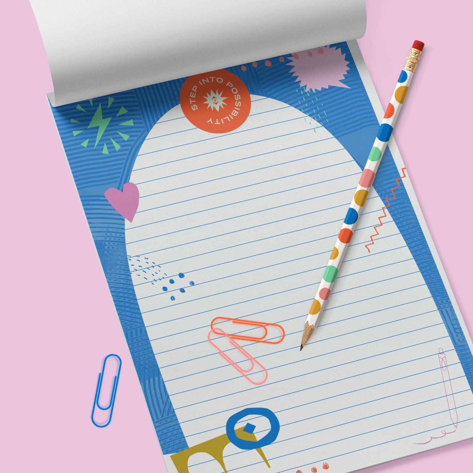 Colorful notepad with the words Step into Possibility on the top in red. Pink background.