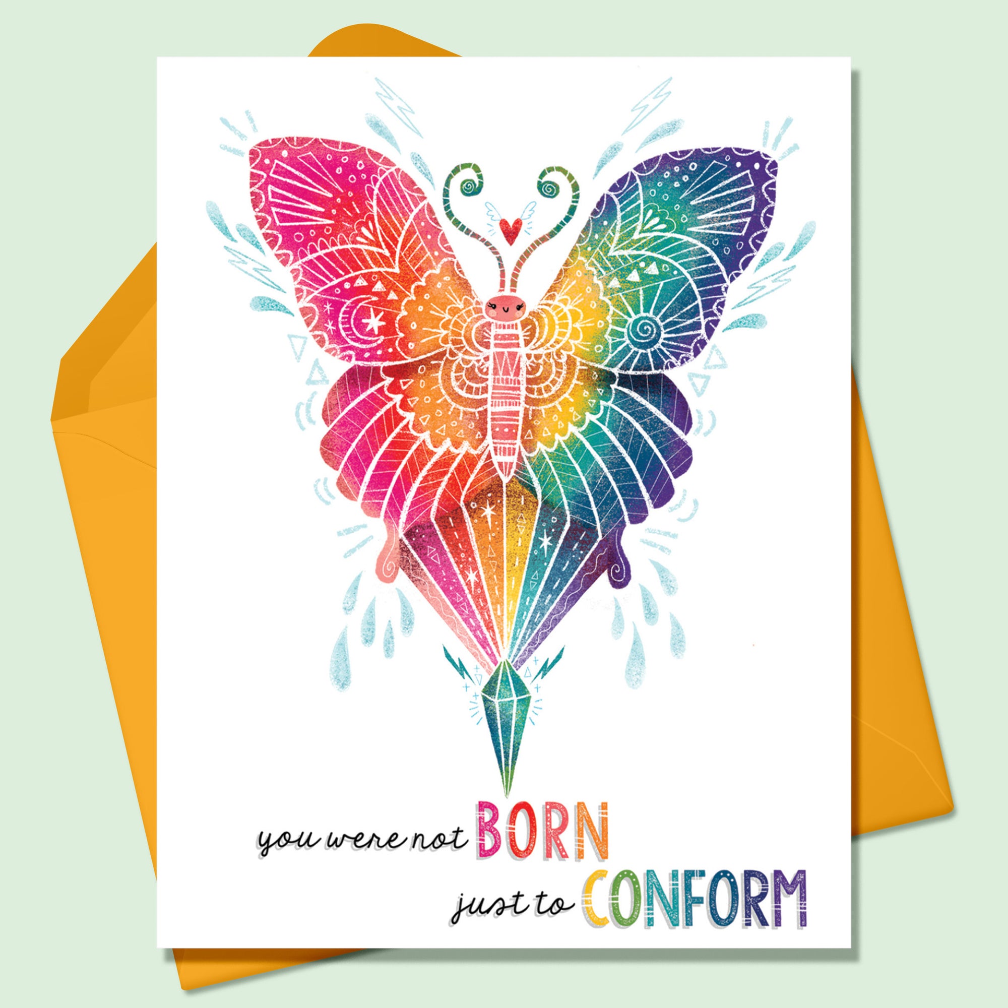 Rainbow colored butterfly image with white decorative details on a white background. The words You Were Not Born Just to Conform written on the greeting card. There is an orange envelope that sits on a mint green background.