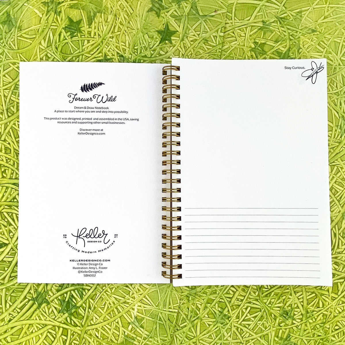 Spiral Bound notebook with white pages, half lines to write on, half blank for drawing. Handpainted green background with swirly textures.