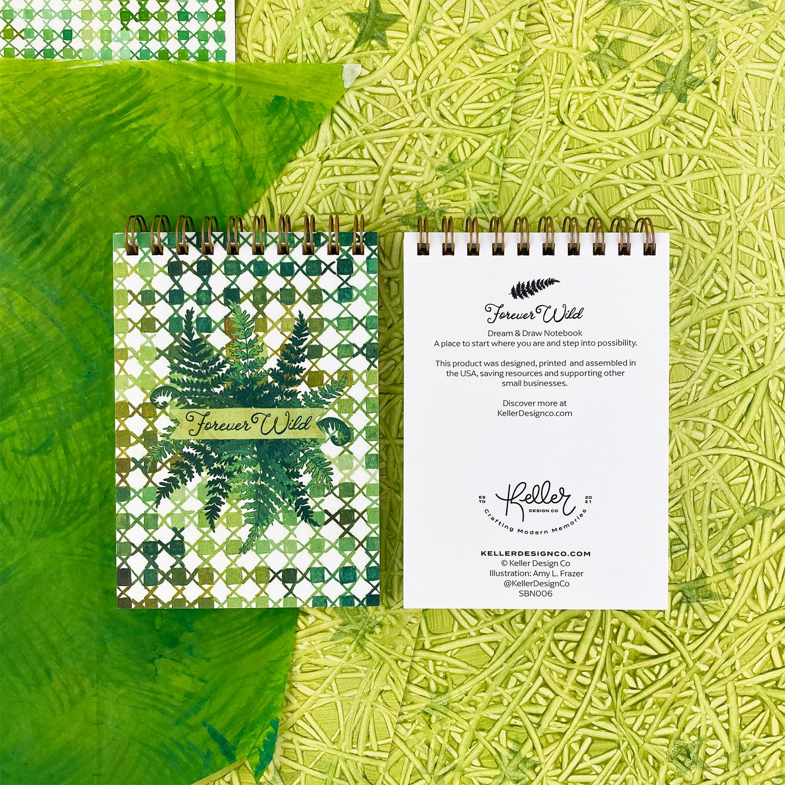 Spiral Bound Notebook with hand painted green checkers and x's. In the center are wild green ferns and the worlds hand lettered "Forever Wild"